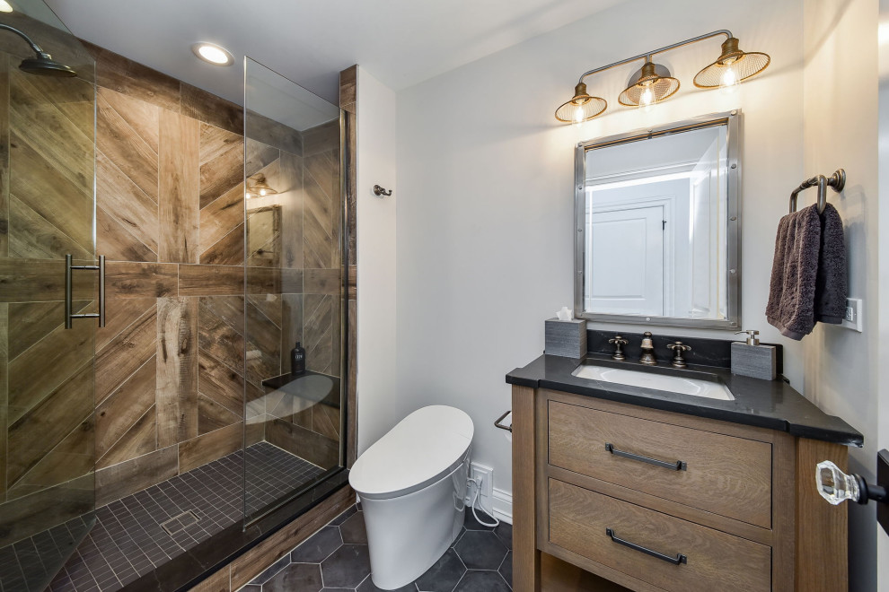 Photo of a mid-sized transitional bathroom in Chicago with flat-panel cabinets, distressed cabinets, an alcove shower, a one-piece toilet, brown tile, wood-look tile, white walls, porcelain floors, an undermount sink, engineered quartz benchtops, white floor, a hinged shower door, black benchtops, a shower seat, a double vanity and a freestanding vanity.