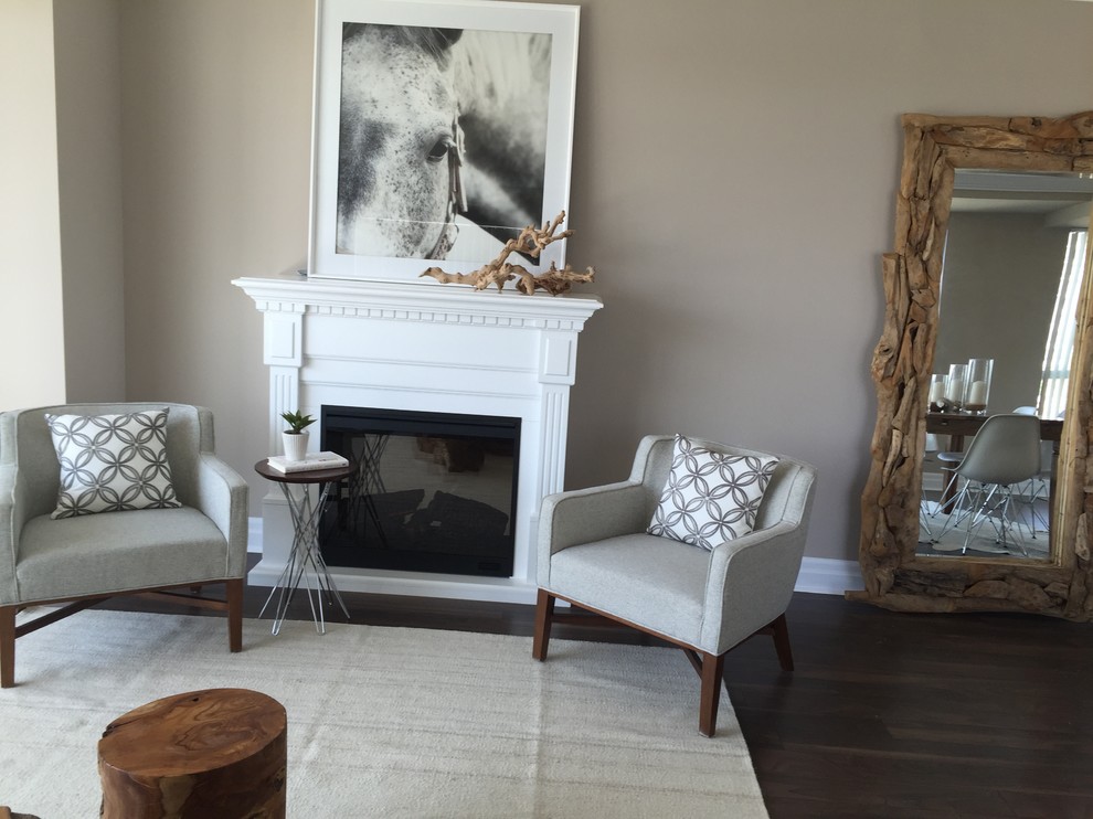 Inspiration for a mid-sized transitional formal open concept living room in Toronto with beige walls, dark hardwood floors, a standard fireplace, a wood fireplace surround, no tv and brown floor.
