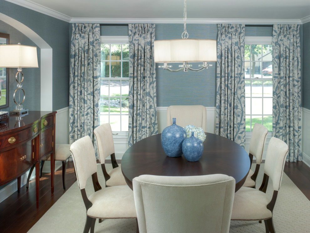 This is an example of a mid-sized transitional separate dining room in Philadelphia with blue walls, dark hardwood floors, no fireplace and brown floor.