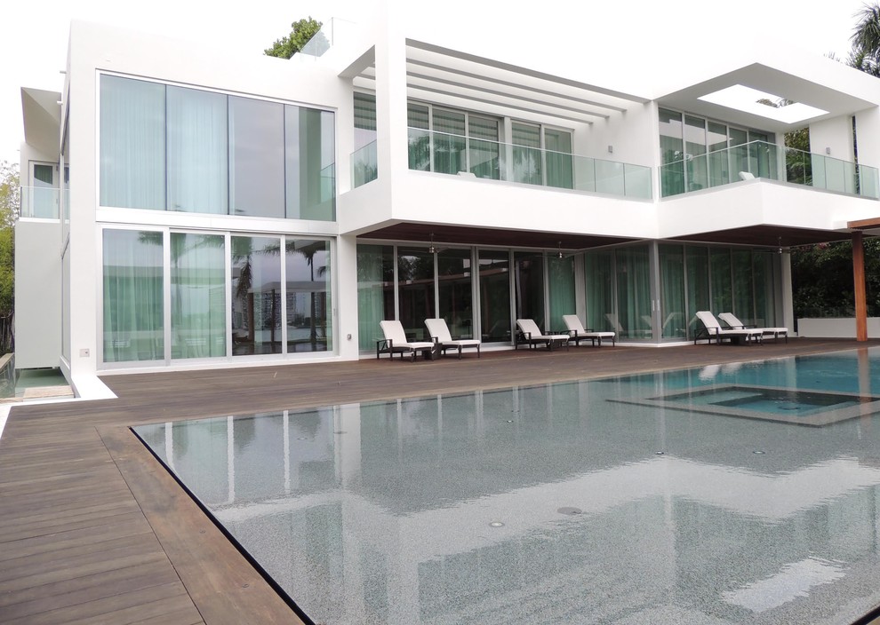 Inspiration for an expansive modern two-storey concrete white exterior in Miami.