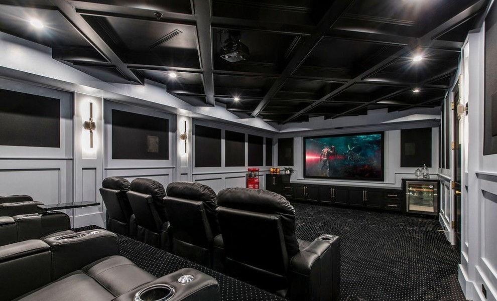 Large contemporary enclosed home theatre in Los Angeles with white walls, carpet, a projector screen and black floor.