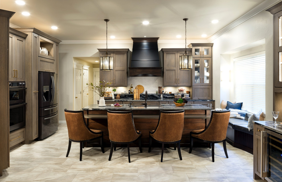 Inspiration for a large transitional l-shaped open plan kitchen in Oklahoma City with shaker cabinets, medium wood cabinets, quartz benchtops, white splashback, porcelain splashback, porcelain floors, with island, grey benchtop, a farmhouse sink, black appliances and grey floor.