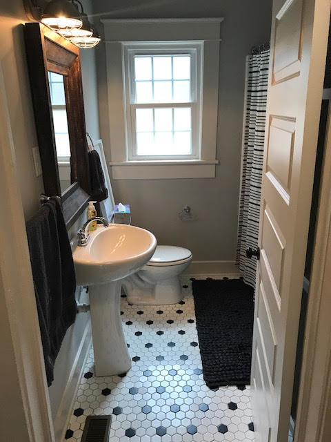 Design ideas for a large transitional 3/4 bathroom in Birmingham with a shower/bathtub combo, a two-piece toilet, white tile, subway tile, beige walls, a pedestal sink, solid surface benchtops, a shower curtain, white benchtops, mosaic tile floors and multi-coloured floor.