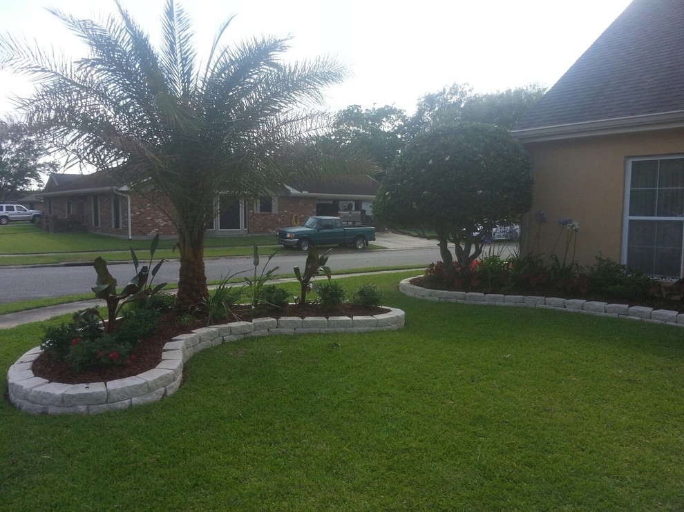 Photo of a mediterranean front yard full sun garden for spring in New Orleans with mulch.