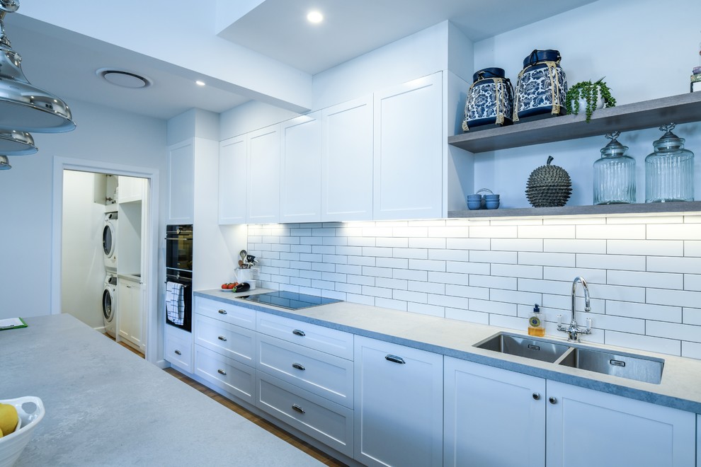 This is an example of a large contemporary open plan kitchen in Sydney.