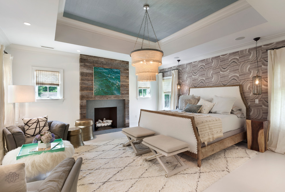 This is an example of a mid-sized transitional master bedroom in New York with multi-coloured walls, a standard fireplace, painted wood floors and a wood fireplace surround.