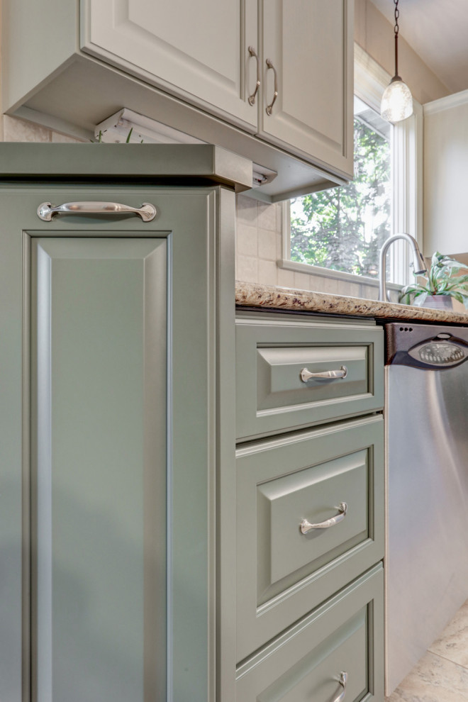 Example of a mid-sized transitional l-shaped ceramic tile and beige floor eat-in kitchen design with a double-bowl sink, raised-panel cabinets, green cabinets, granite countertops, beige backsplash, ceramic backsplash, stainless steel appliances, an island and beige countertops