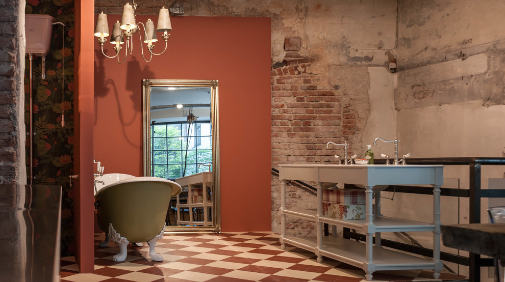 Large traditional bathroom in Munich with a freestanding tub, a two-piece toilet, red walls, cement tiles, a wall-mount sink and white floor.