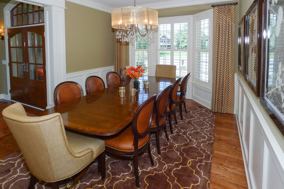 This is an example of a traditional dining room in Minneapolis with beige walls and medium hardwood floors.