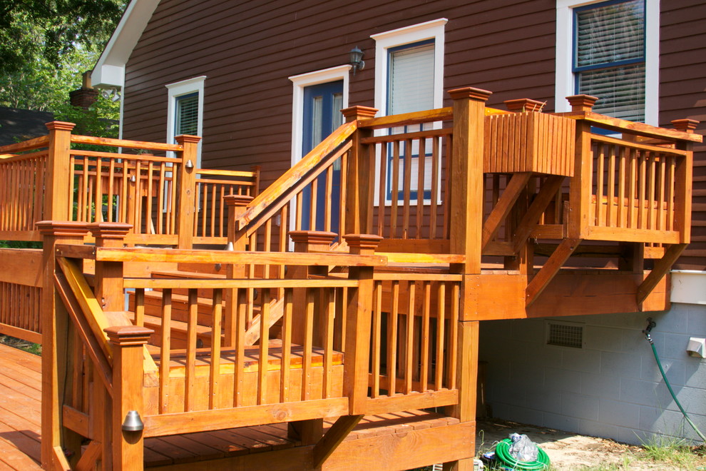 This is an example of a mid-sized traditional backyard deck in Atlanta with no cover.