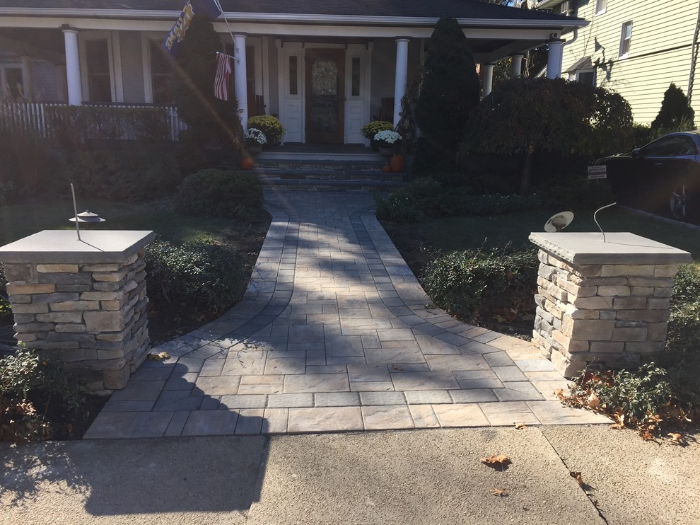 Design ideas for a large traditional front yard partial sun formal garden for summer in New York with a garden path and natural stone pavers.