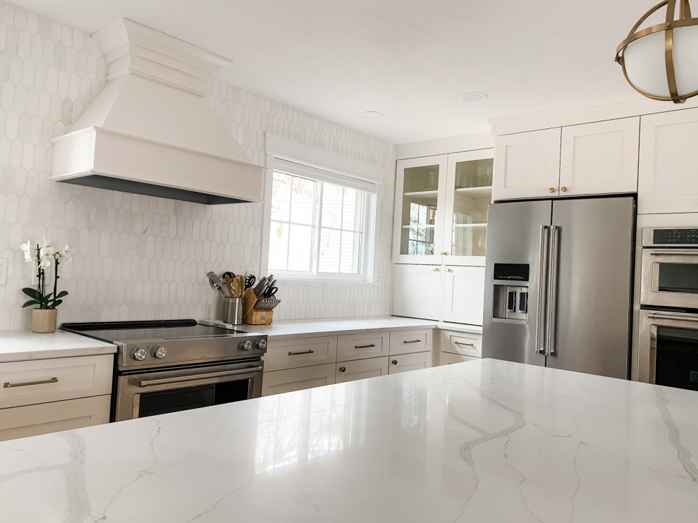 Photo of a large transitional l-shaped open plan kitchen in Denver with an undermount sink, shaker cabinets, white cabinets, white splashback, with island, white benchtop and coffered.