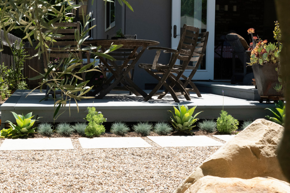 Mid-sized contemporary backyard full sun xeriscape in Santa Barbara with with rock feature and concrete pavers.