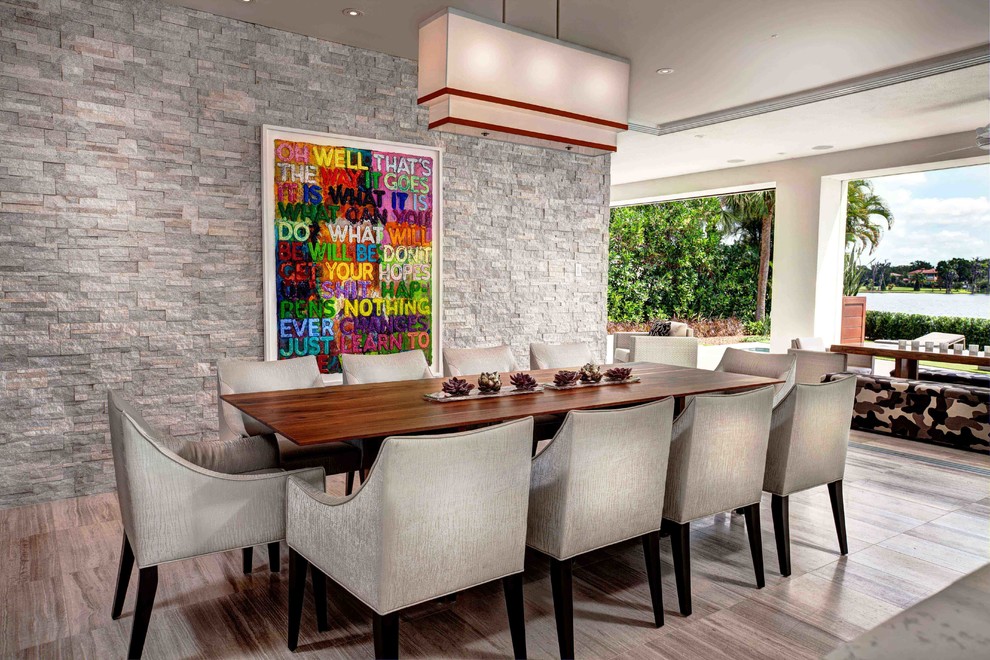 This is an example of a contemporary dining room in Orlando with white walls.