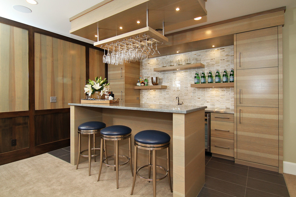 Photo of a large transitional single-wall seated home bar in Minneapolis with flat-panel cabinets, light wood cabinets, multi-coloured splashback, ceramic splashback and porcelain floors.