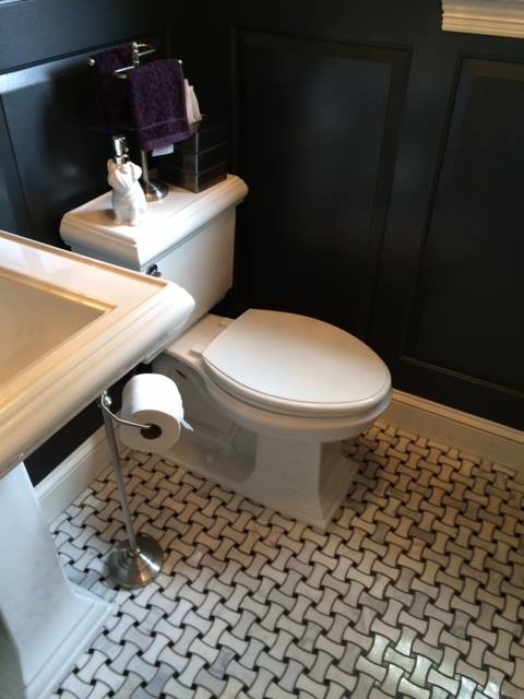 Small transitional 3/4 bathroom in Denver with a console sink and black walls.