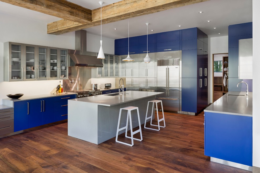 Large contemporary u-shaped kitchen in Denver with an undermount sink, flat-panel cabinets, blue cabinets, quartz benchtops, white splashback, stainless steel appliances, dark hardwood floors and multiple islands.