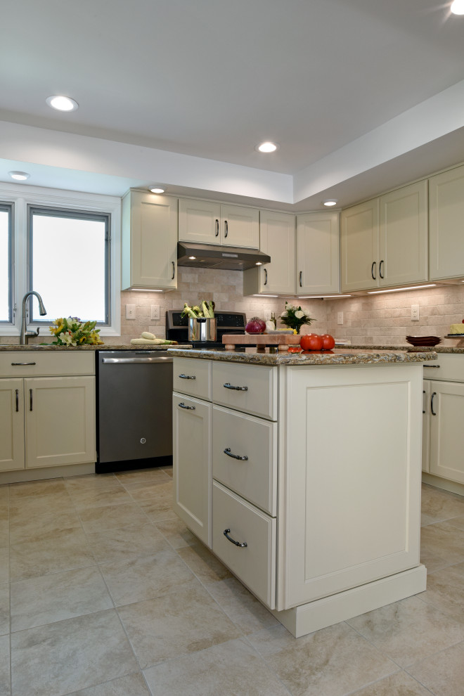 Mid-sized transitional u-shaped porcelain tile, beige floor and tray ceiling enclosed kitchen photo with an undermount sink, flat-panel cabinets, beige cabinets, quartz countertops, beige backsplash, travertine backsplash, black appliances, an island and beige countertops