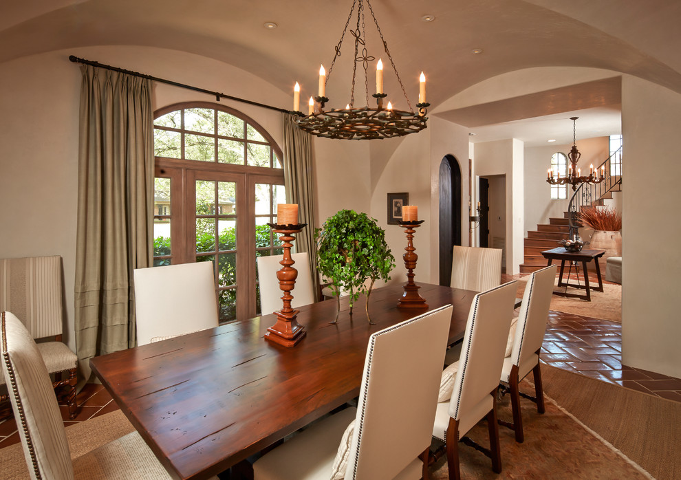 Inspiration for a mediterranean dining room in Houston with terra-cotta floors.
