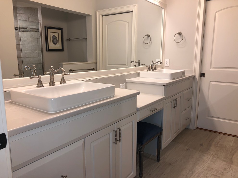 Design ideas for a small transitional master bathroom in Raleigh with raised-panel cabinets, white cabinets, a two-piece toilet, grey walls, porcelain floors, a drop-in sink, solid surface benchtops, grey floor and grey benchtops.