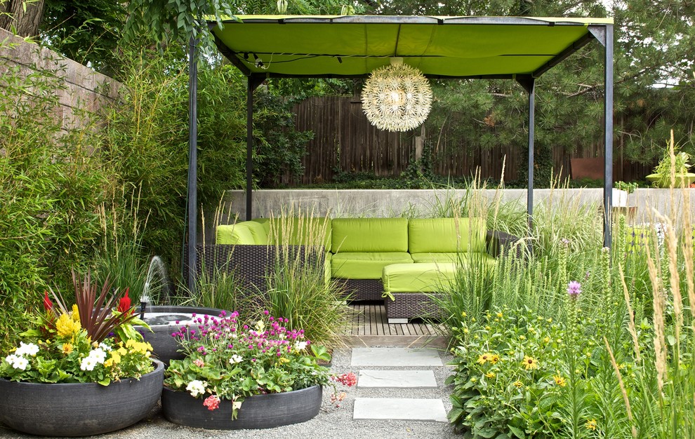This is an example of a midcentury patio in Denver with a water feature.