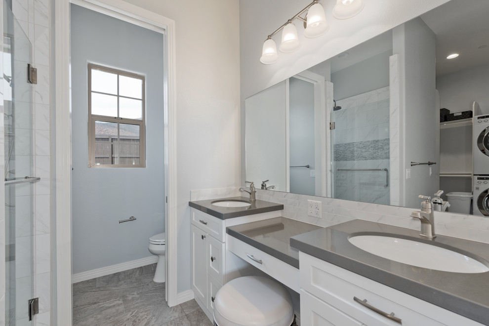 This is an example of a mid-sized traditional kids bathroom in San Diego with shaker cabinets, white cabinets, a corner shower, gray tile, matchstick tile, grey walls, porcelain floors, an undermount sink, engineered quartz benchtops, grey floor and a hinged shower door.