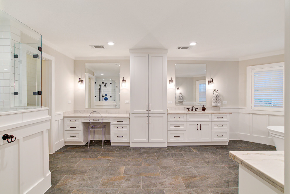 Photo of a country master bathroom in Houston with shaker cabinets, white cabinets, a freestanding tub, a corner shower, a one-piece toilet, white tile, ceramic tile, white walls, porcelain floors, an undermount sink, quartzite benchtops, grey floor, a hinged shower door and white benchtops.