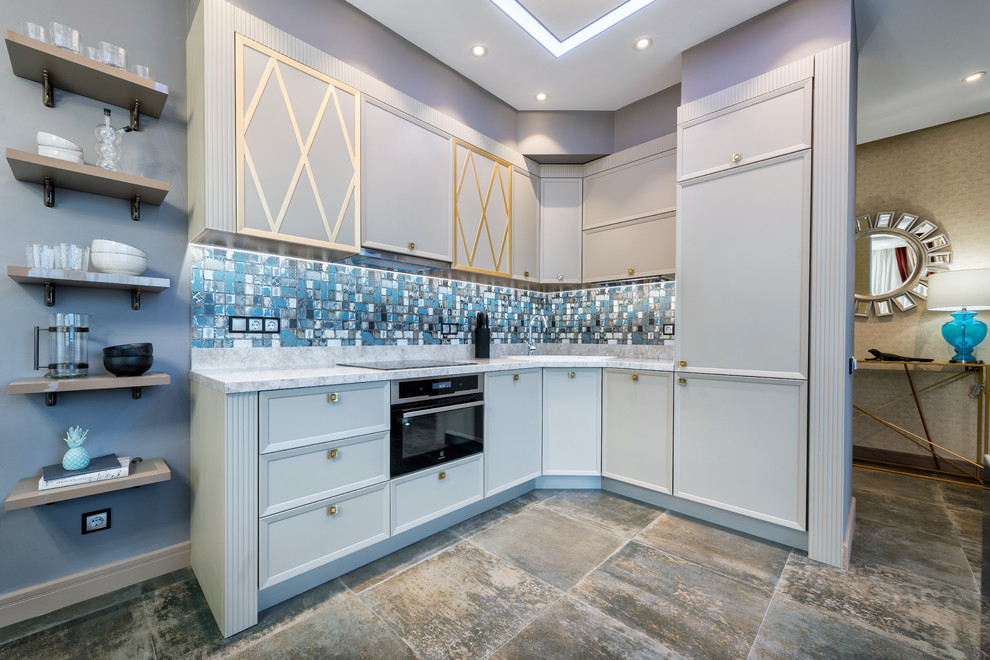 Photo of a transitional l-shaped open plan kitchen in Other with a drop-in sink, recessed-panel cabinets, white cabinets, stainless steel appliances, no island, grey floor and blue benchtop.