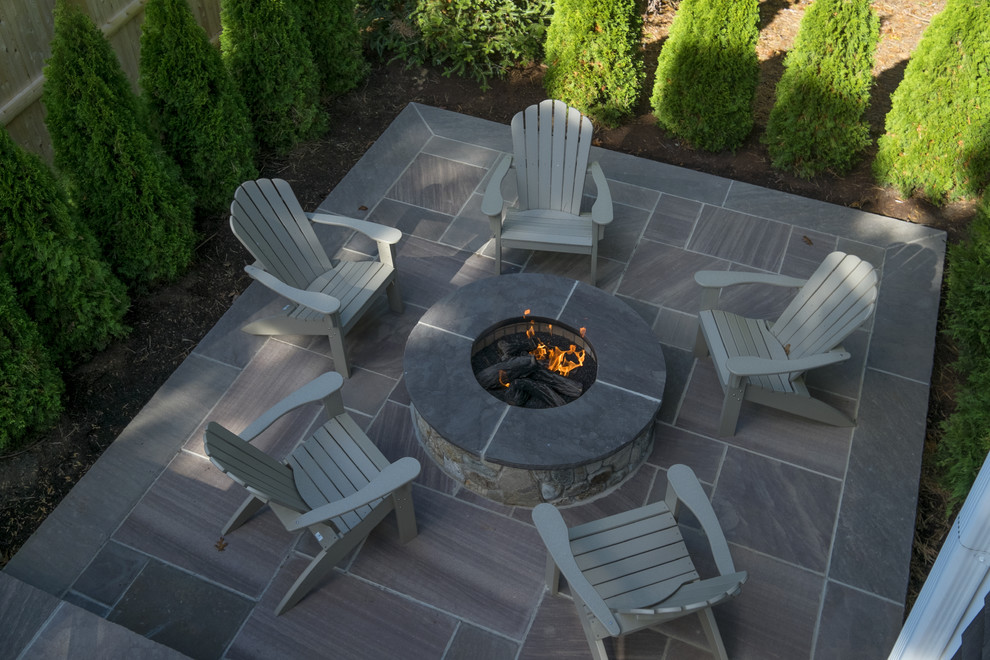 Inspiration for a small beach style backyard patio in Boston with a fire feature, natural stone pavers and no cover.