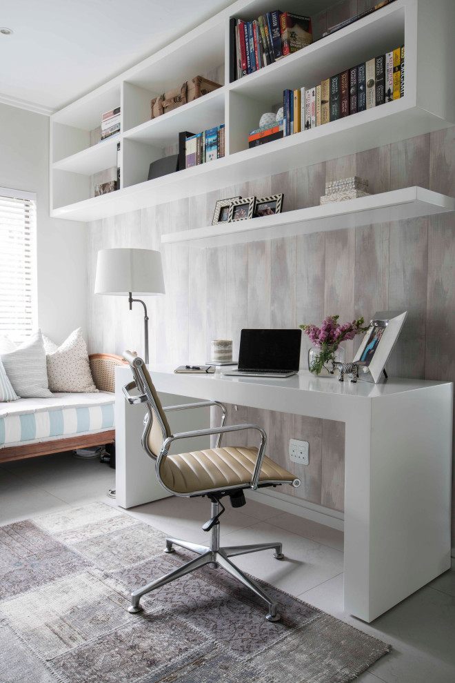 Photo of a mid-sized transitional study room in Other with multi-coloured walls, a freestanding desk, grey floor and wallpaper.