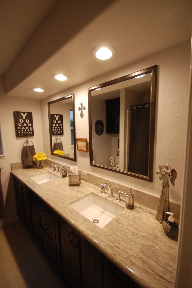 Photo of a mid-sized transitional kids bathroom with an undermount sink, flat-panel cabinets, dark wood cabinets, granite benchtops, a two-piece toilet, white tile, wood-look tile, grey walls and porcelain floors.