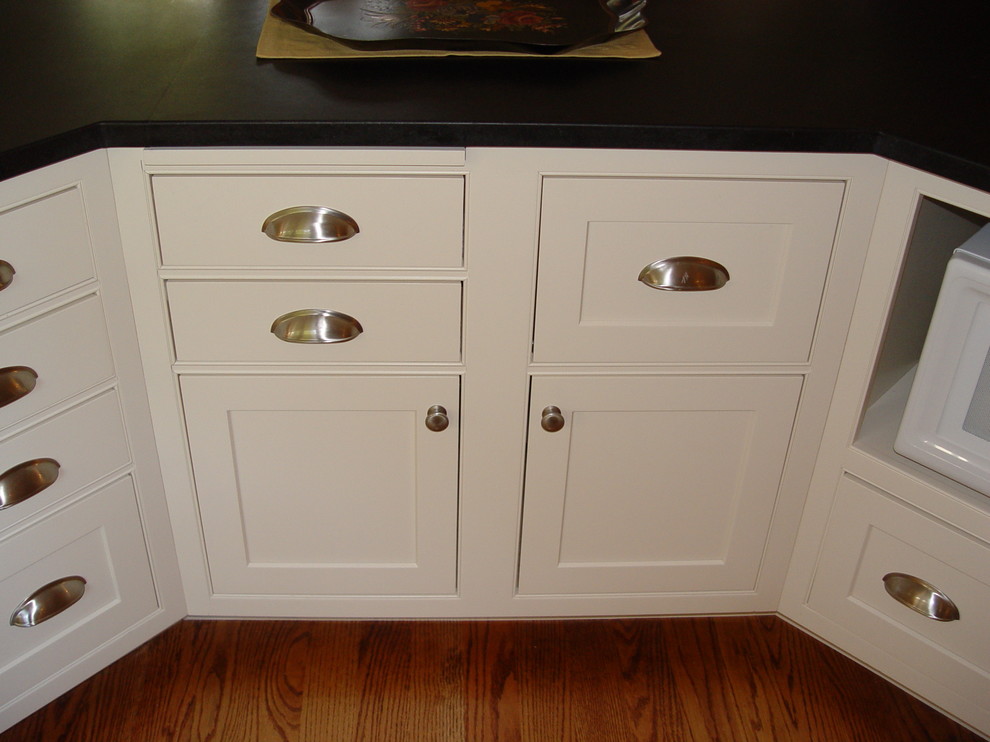 Example of a transitional medium tone wood floor eat-in kitchen design in Boston with an undermount sink, beaded inset cabinets, white cabinets, granite countertops, white backsplash, subway tile backsplash, paneled appliances, yellow walls and an island
