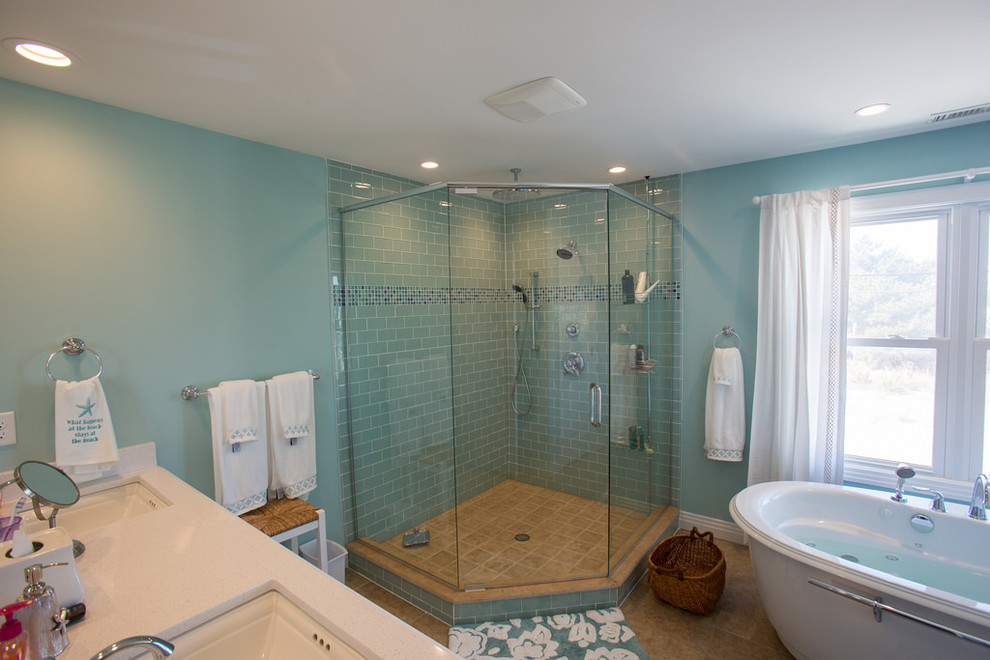 Mid-sized beach style master bathroom in Other with beaded inset cabinets, white cabinets, a freestanding tub, a corner shower, blue tile, ceramic tile, blue walls, travertine floors, an undermount sink and engineered quartz benchtops.