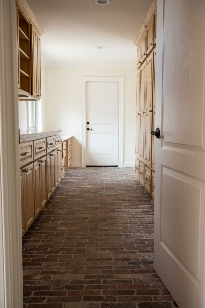 Mudroom - large brick floor and multicolored floor mudroom idea with beige walls