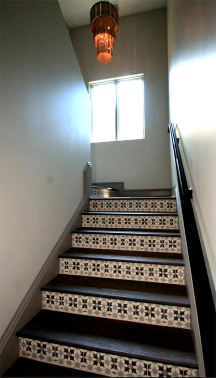 Mid-sized tuscan wooden u-shaped staircase photo in Tampa with tile risers