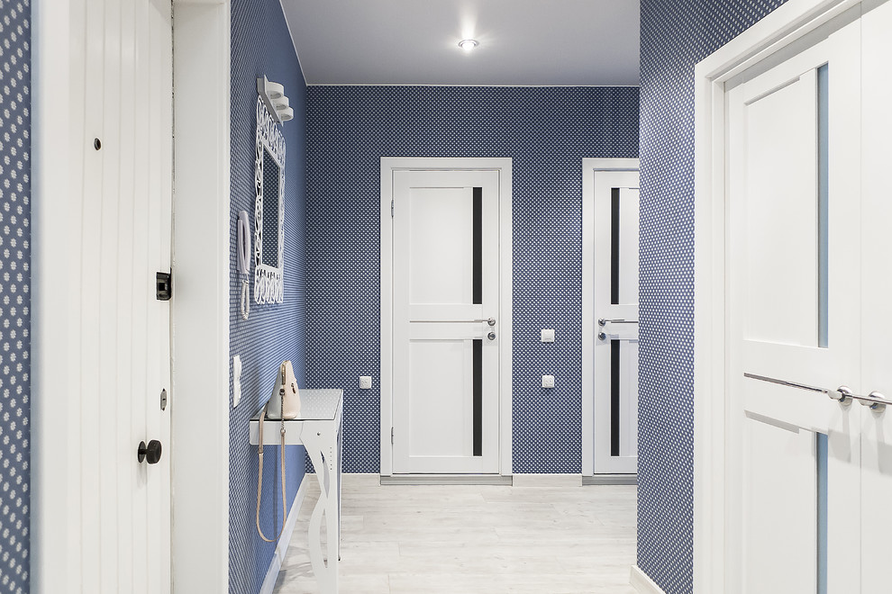 Photo of a mid-sized contemporary front door in Saint Petersburg with blue walls, vinyl floors, a single front door, a white front door, grey floor and wallpaper.
