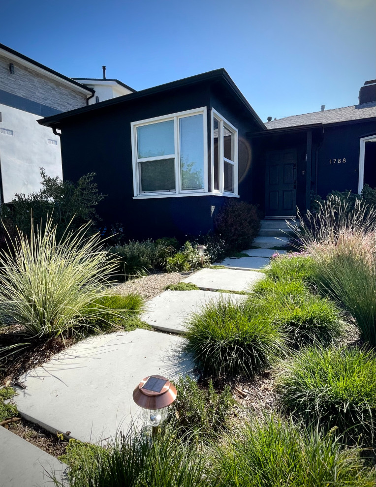 This is an example of a large eclectic front xeriscape full sun garden in Los Angeles with a garden path and gravel.
