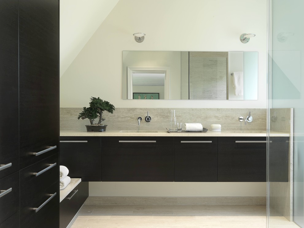 Inspiration for a mid-sized contemporary master bathroom in St Louis with flat-panel cabinets, black cabinets, a curbless shower, a one-piece toilet, black tile, porcelain floors, marble benchtops, porcelain tile, white walls and an undermount sink.