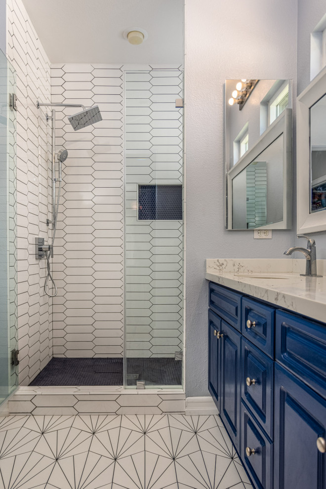 Medium sized contemporary ensuite bathroom in San Diego with shaker cabinets, blue cabinets, a corner shower, white tiles, porcelain tiles, blue walls, porcelain flooring, a submerged sink, engineered stone worktops, white floors, a hinged door, grey worktops, a wall niche, double sinks and a built in vanity unit.