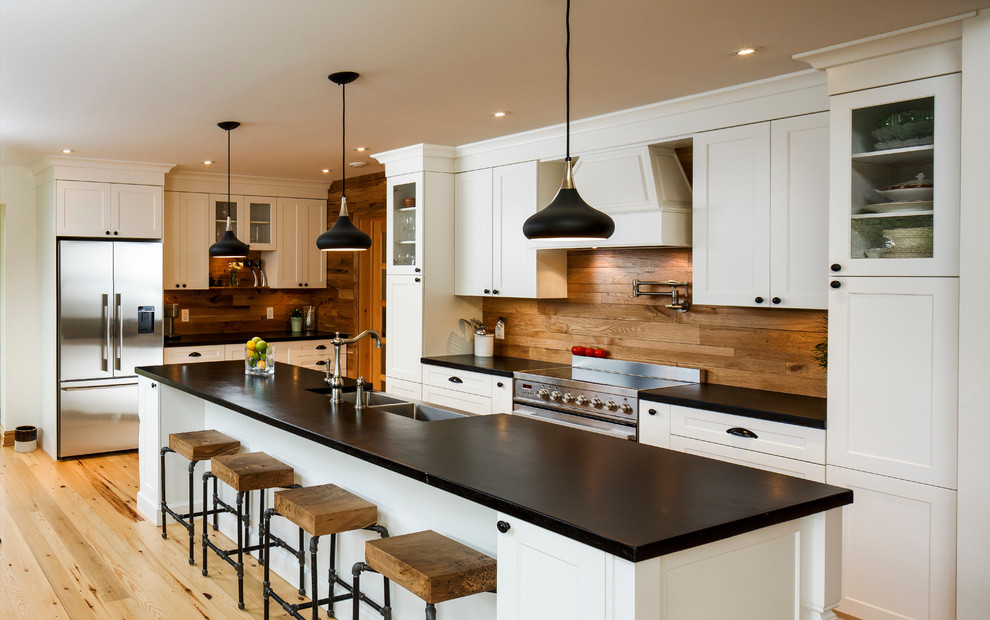 Inspiration for a transitional kitchen in Toronto with a double-bowl sink, shaker cabinets, stainless steel appliances, light hardwood floors and with island.