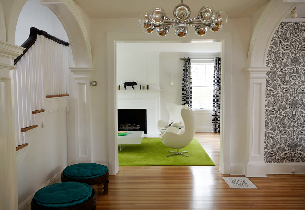 Photo of a mid-sized contemporary foyer in New York with white walls, medium hardwood floors and a single front door.