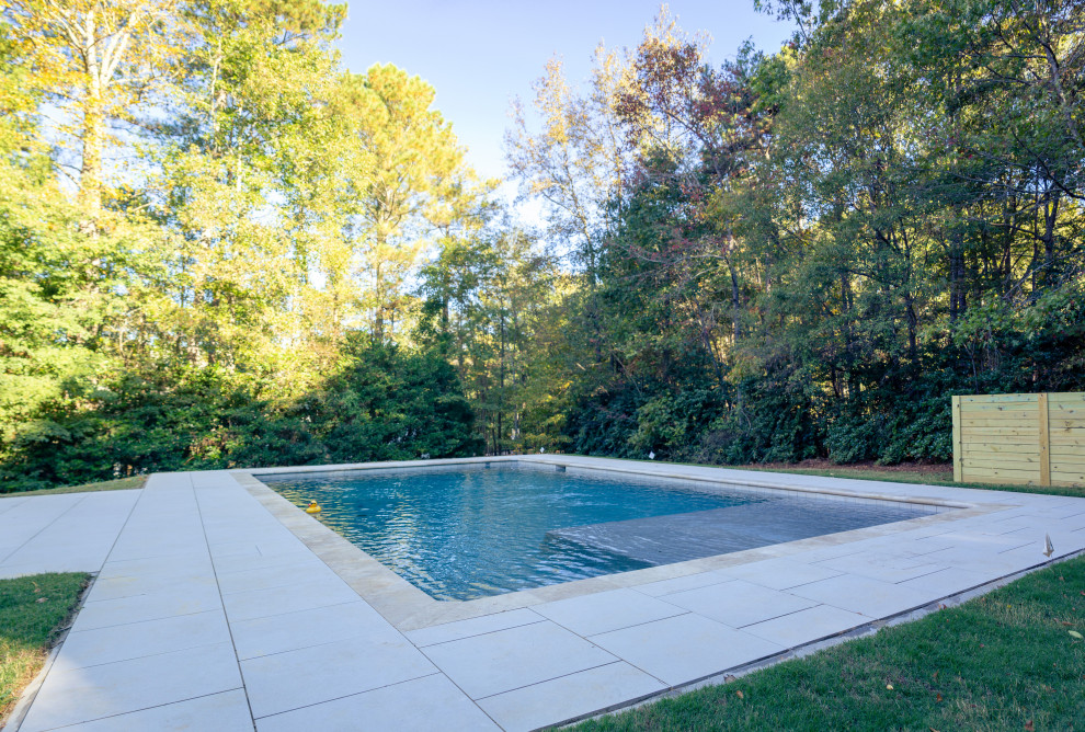 Pool - large transitional backyard stone and rectangular pool idea in Atlanta