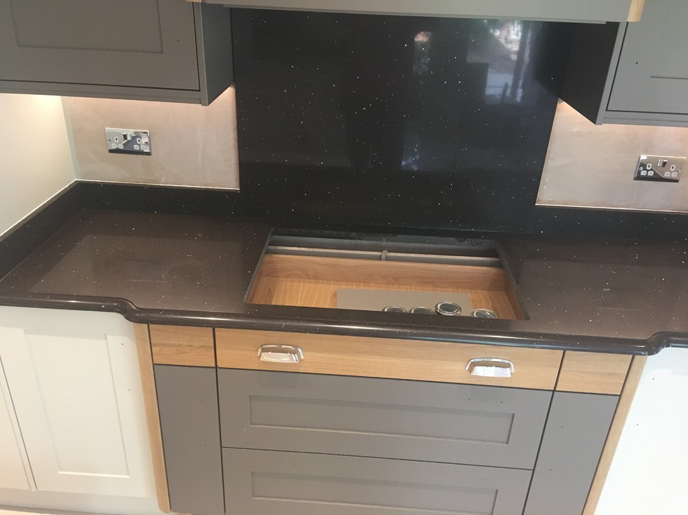 This is an example of an expansive modern l-shaped eat-in kitchen in Other with grey cabinets, quartzite benchtops, brown splashback, stone slab splashback, no island, beige floor and brown benchtop.