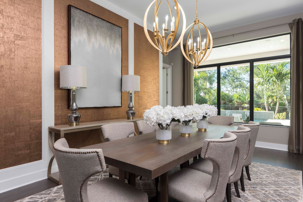 Design ideas for a transitional dining room in Miami with metallic walls, medium hardwood floors and wallpaper.