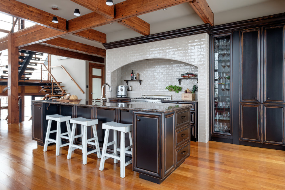 Kitchen - rustic single-wall kitchen idea in Montreal with a farmhouse sink, stainless steel appliances and an island