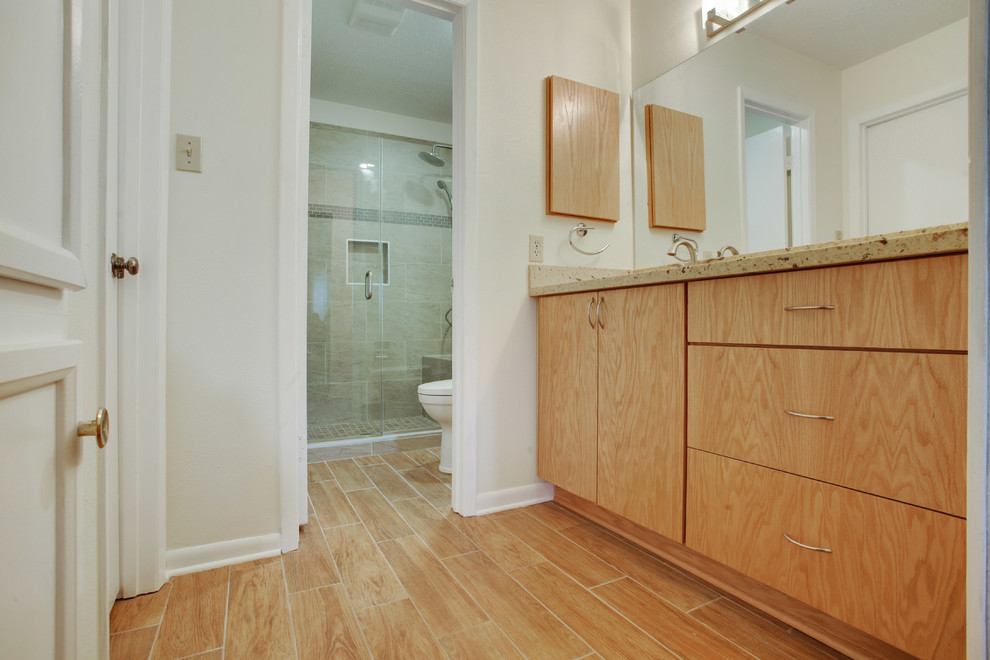 Small transitional master bathroom in New Orleans with an undermount sink, flat-panel cabinets, light wood cabinets, quartzite benchtops, an open shower, a two-piece toilet, beige tile, porcelain tile, grey walls and porcelain floors.