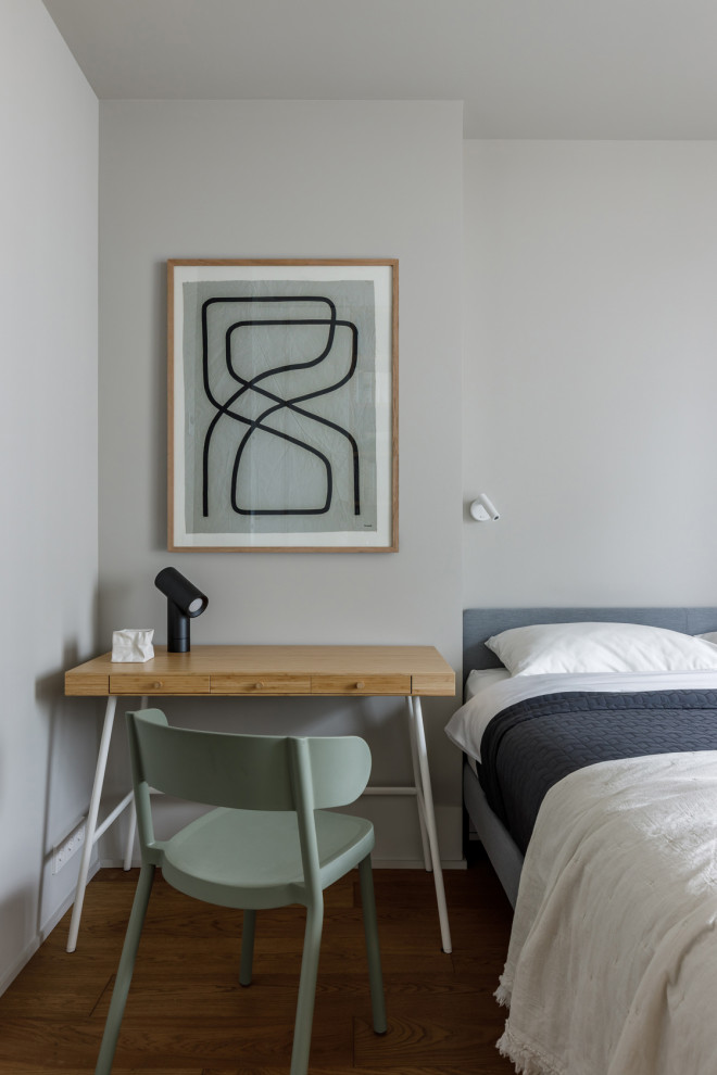 Стильный дизайн: хозяйская спальня среднего размера в современном стиле с серыми стенами, паркетным полом среднего тона, коричневым полом и рабочим местом без камина - последний тренд