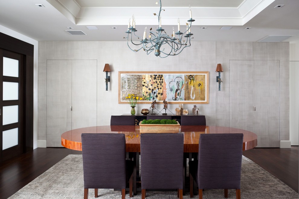 Photo of a contemporary dining room in New York with dark hardwood floors, no fireplace and grey walls.