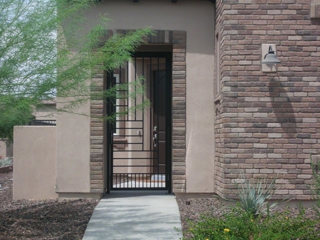 Design ideas for a large two-storey brown exterior in Phoenix with stone veneer.