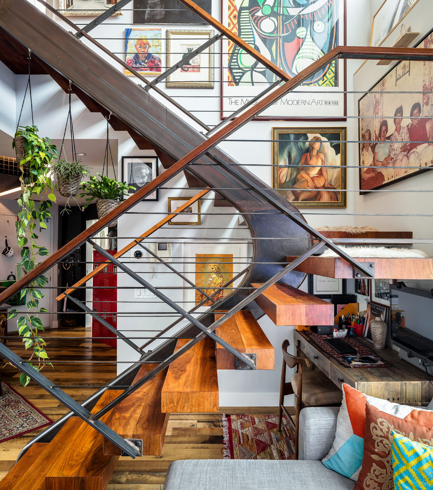 Design ideas for an eclectic wood u-shaped staircase in New York with open risers and mixed railing.